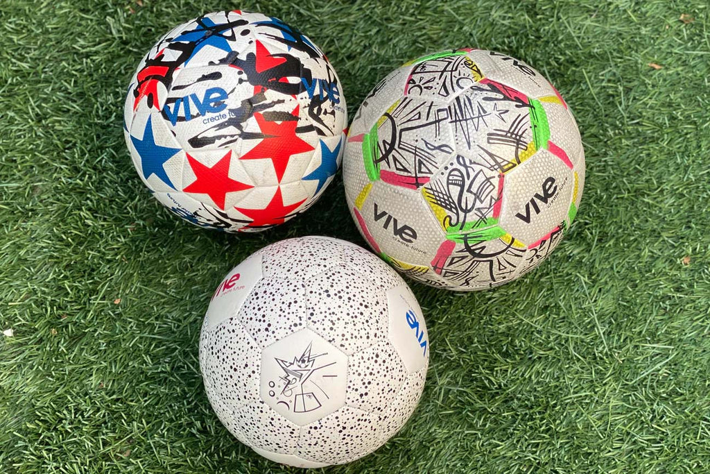 Soccer balls multi colored on grass field