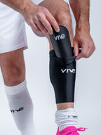 Victory Soccer Shin Guards on Model Sleeve View - Black color with White design from VIVE