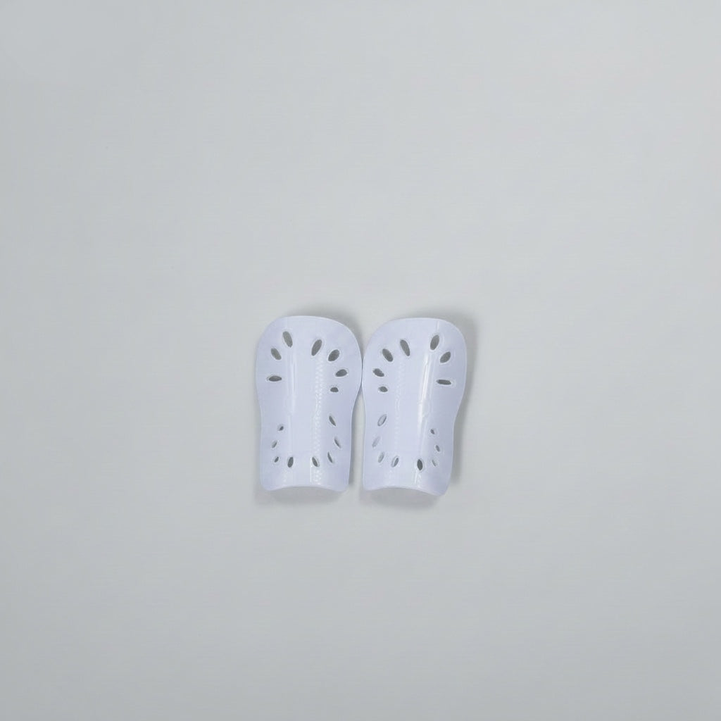 VIVE Create Future white soccer shin guards with perforated design for ventilation and impact absorption.