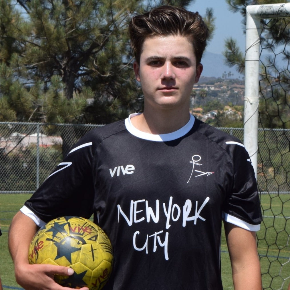 Ultimate Strike 22 NYC Soccer Jersey view of soccer player - Black color with white lettering from VIVE